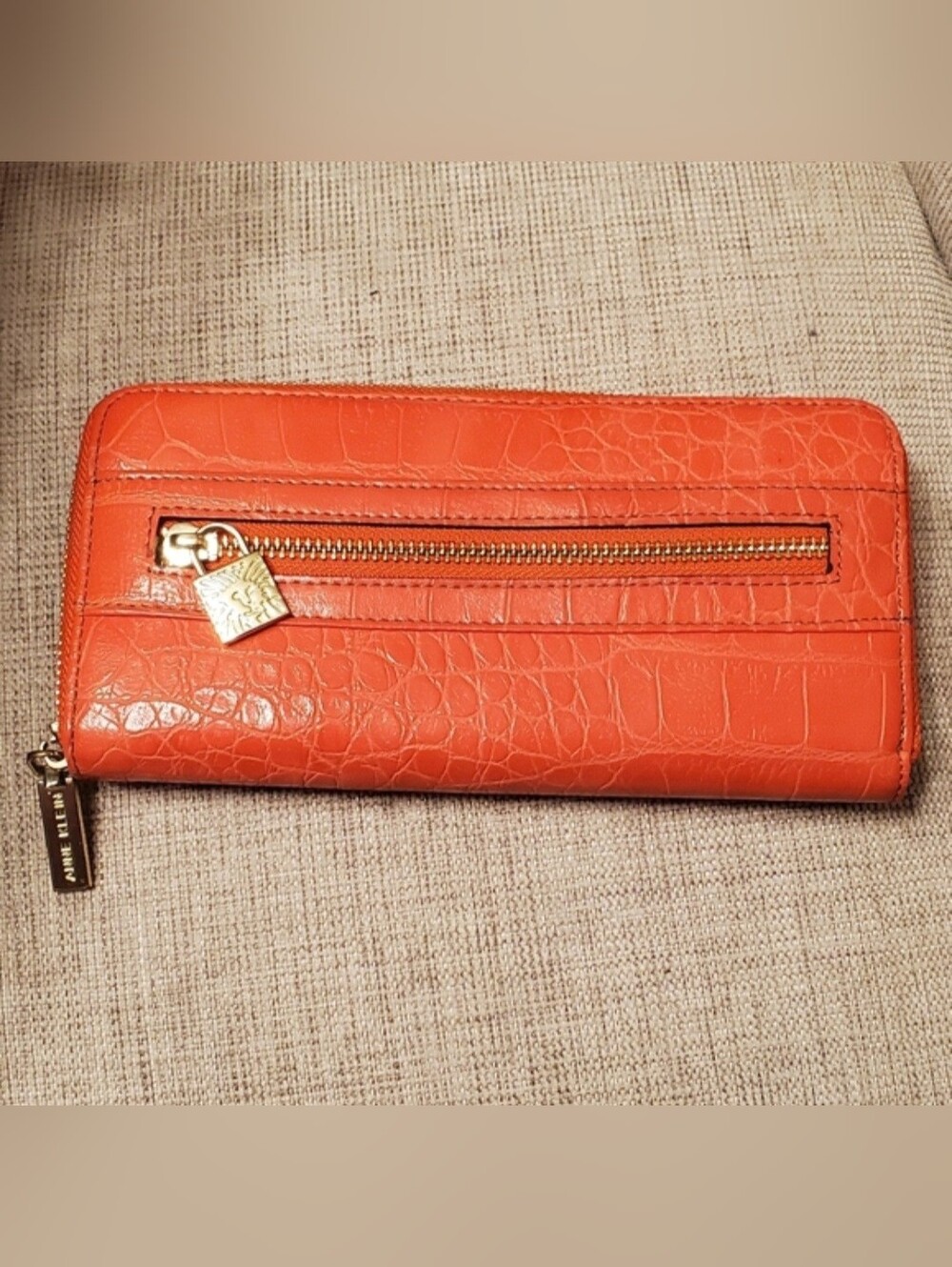 Anne Klein zippered wallet, orange with gold zippers and embellishment lock.